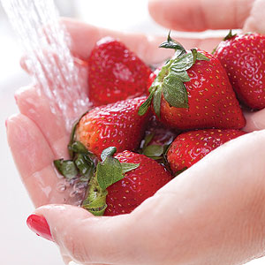 Cleaning fruits under water.